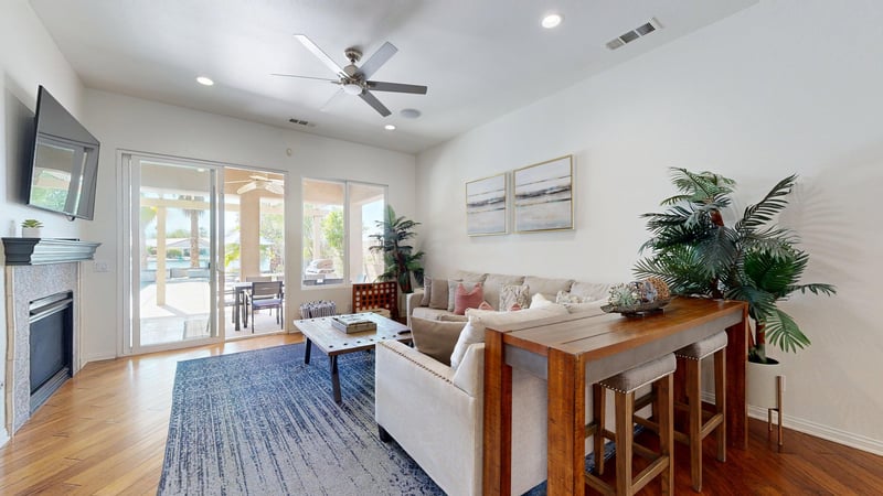 Living room includes direct patio access where water and mountain views can be seen.