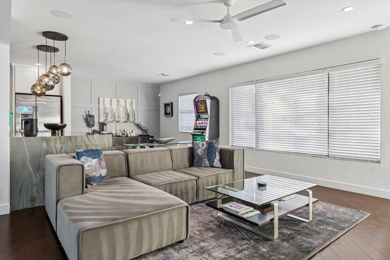Views of the kitchen and incredible slot machine can be seen behind the living room area.