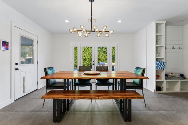 Dining area with table, bench seating, and chairs for up to 6 guests just off of the kitchen.