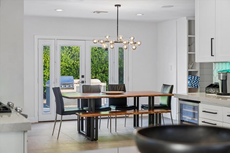 Dining area with table, bench seating, and chairs for up to 6 guests just off of the kitchen.