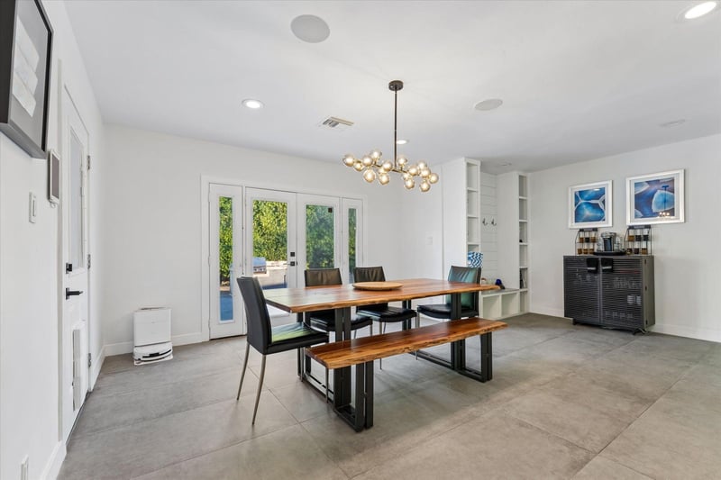 Dining area with table, bench seating, and chairs for up to 6 guests just off of the kitchen.