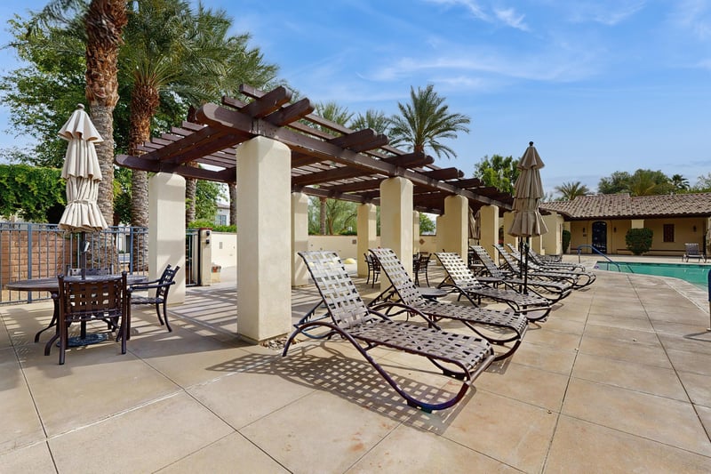 Shared sunloungers near the pool and hot tub.
