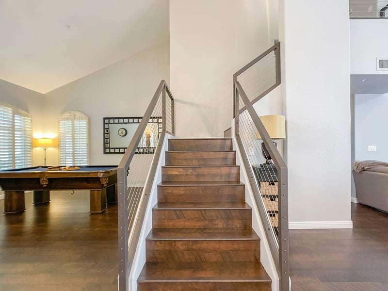 The sleek and slightly industrial stairwell heading toward second floor
