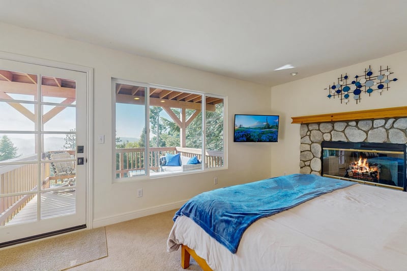 King size bed, smart TV, fireplace, private deck access, and ensuite bathroom.