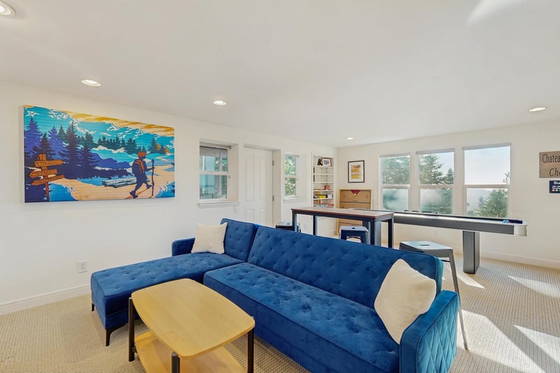Smart TV, shuffleboard, darts, deck access, and a sofa pullout twin bed.
