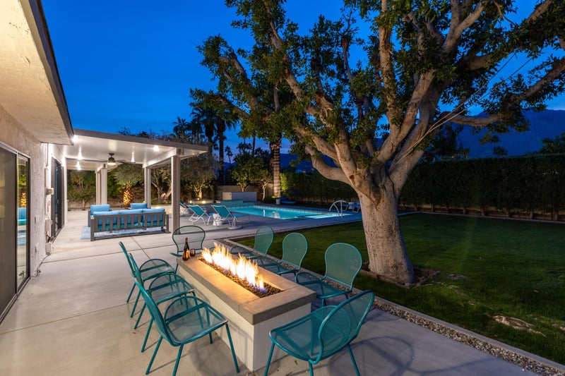 Beautiful landscaping surrounds the fire pit