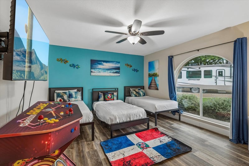 Three twin beds, flatscreen TV, large window with plenty of natural lighting, and games for all ages