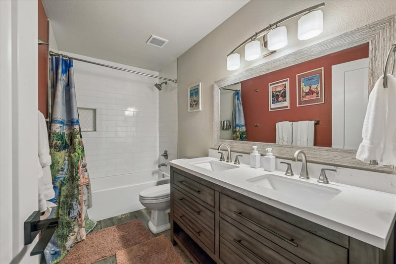 Dual vanity with a shower and tub combination.