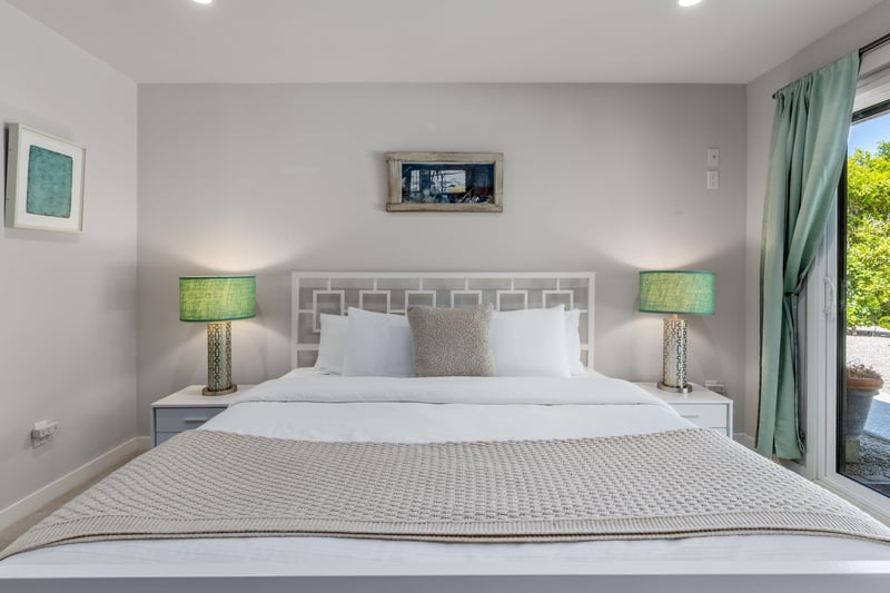 King bed, Smart TV, patio access, and ensuite bathroom.