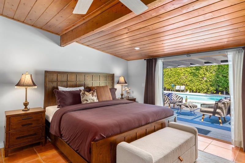 King bed, smart TV, patio access, and ensuite bathroom.