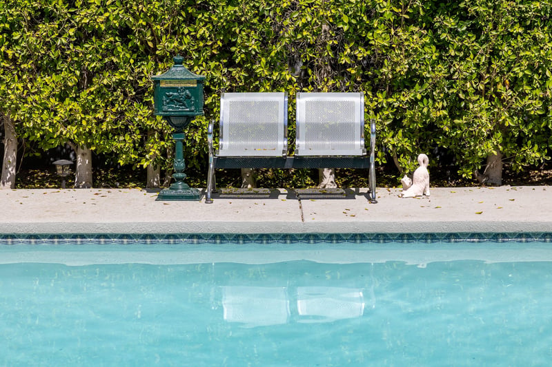 Entertainers backyard with outdoor seating, private pool and spa, sun loungers, cabana, and outdoor dining space.