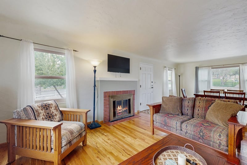 A view of the fireplace, TV, and dining area located just off of the living room.