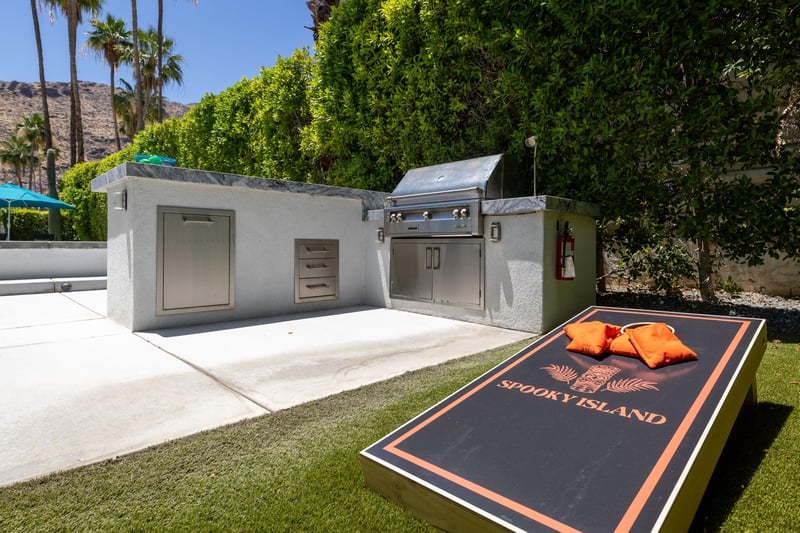 The side lawn is the perfect spot for a game of corn hole. Located next to the BBQ grill.