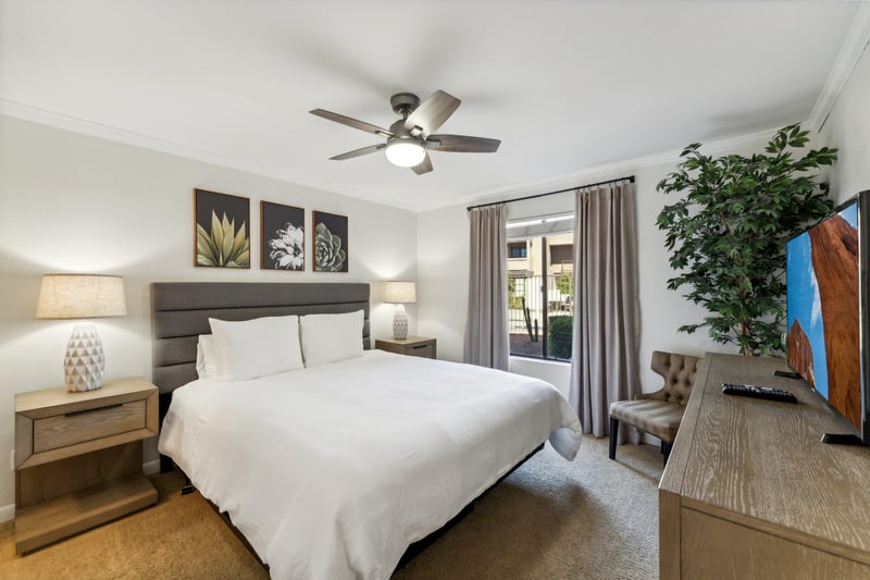 Private Bedroom features a California King bed, bright furnishings and a Smart TV