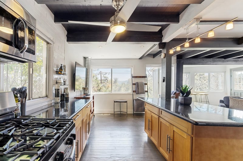 Equipped with stainless steel appliances, spacious island, and cooking essentials.