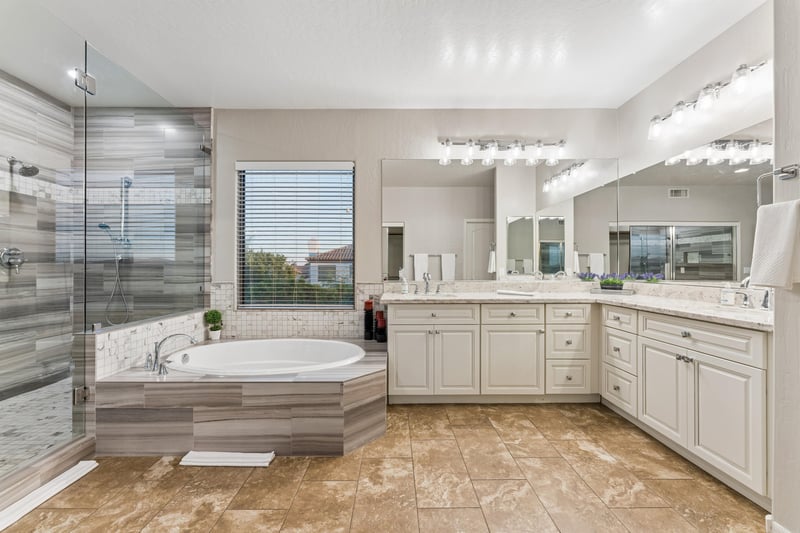 Ensuite bathroom with stand alone bathtub, walkin shower, and dual vanity sinks.