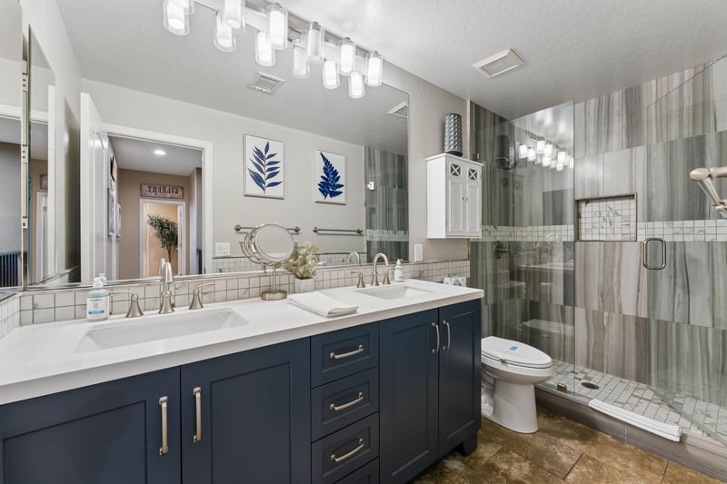 Dual vanity sinks, walkin shower, and modern finishes.