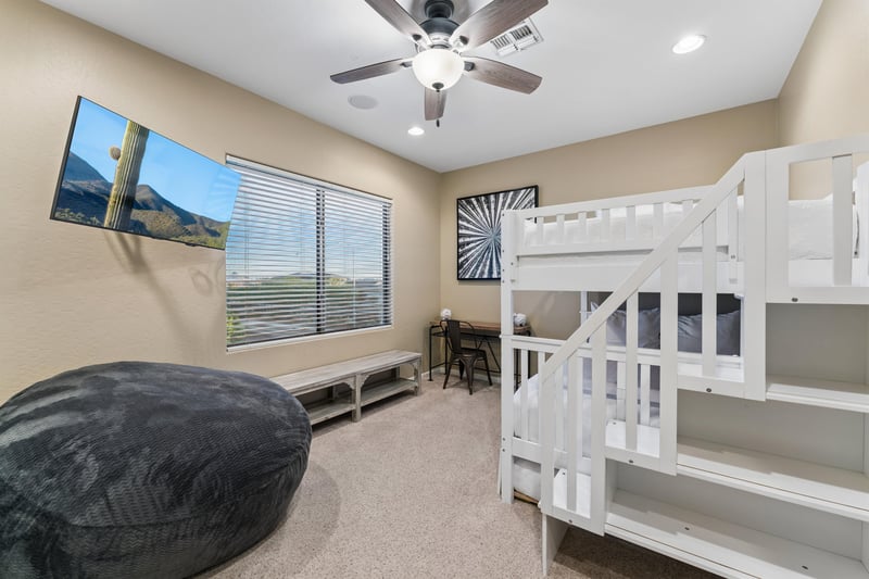 Full over full bunk bed, twin trundle bed, flatscreen TV, beanbag, and desk space.