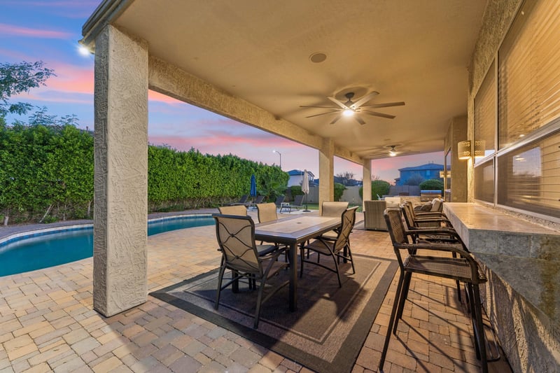 Plenty of outdoor seating on the patio overlooking the pool area, with outdoor ceiling fans.