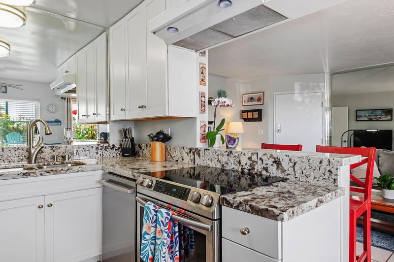 Kitchen facing living room with serving area for guests.