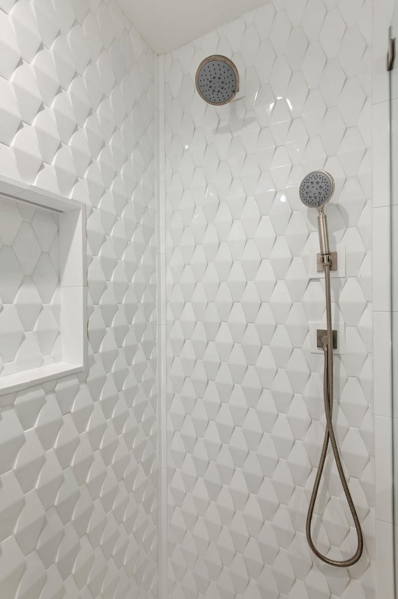 Walkin shower with two shower heads.