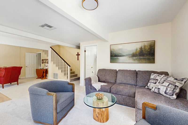 Located on the lower level of the home with ample seating, flatscreen TV, full bathroom, and an additional sitting area with a fireplace.