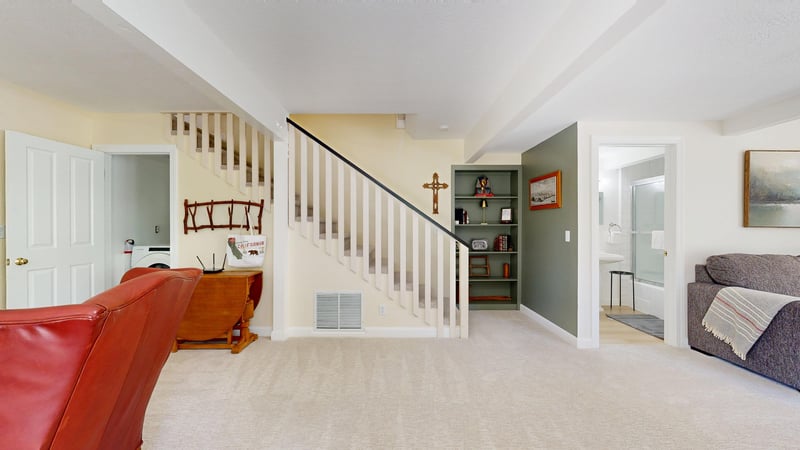 Located on the lower level of the home with ample seating, flatscreen TV, full bathroom, and an additional sitting area with a fireplace.