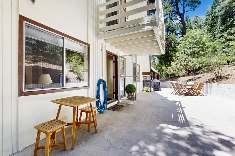 Back patio with outdoor seating, dining area, and BBQ grill.