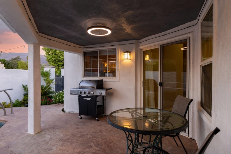 Patio area features a BBQ and patio seating.