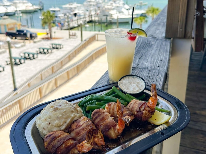 Bacon wrapped shrimp and a cocktail overlooking the harbor