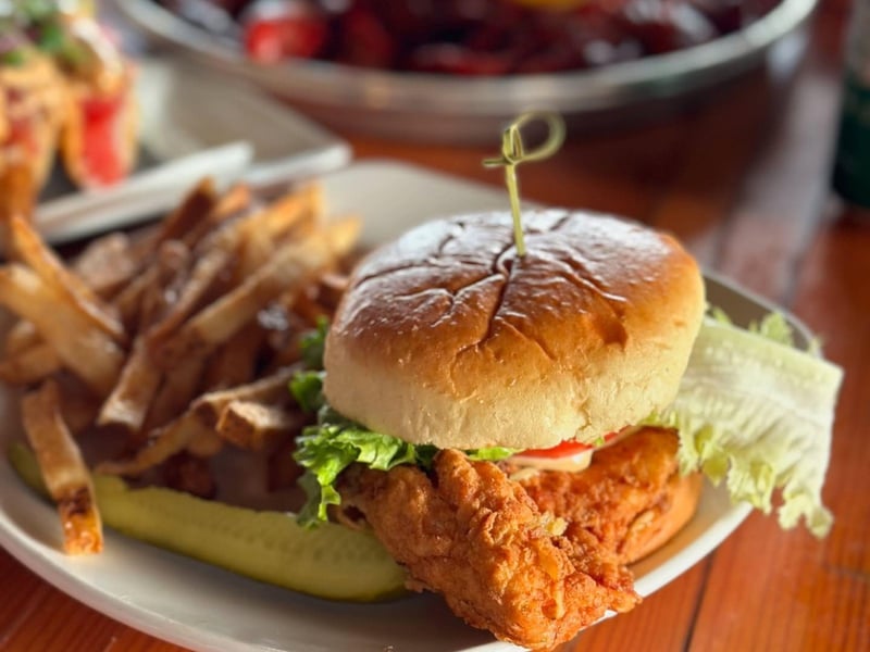 A fried chicken sandwich with fries