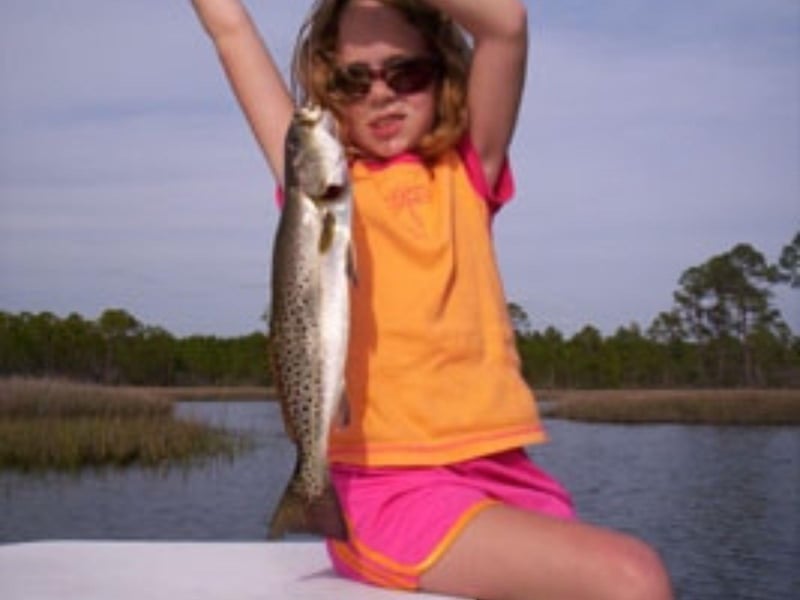 A young girl showing off her catch