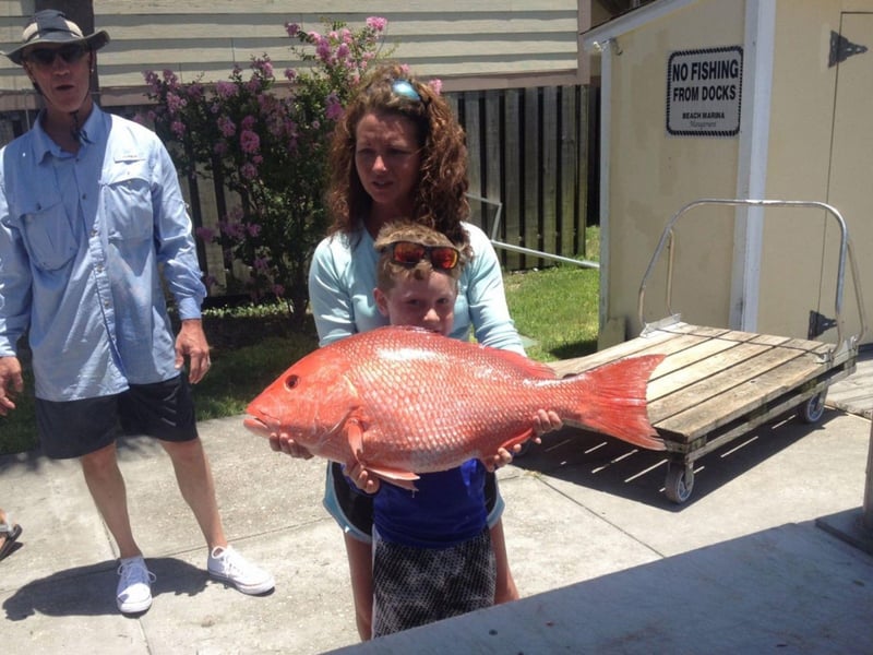 A young boy with his catch from Heads n Scales Fishing Charter
