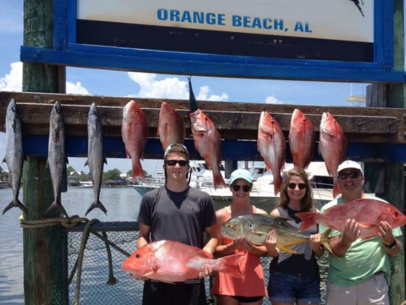 Fishers showing off their catches on the dock
