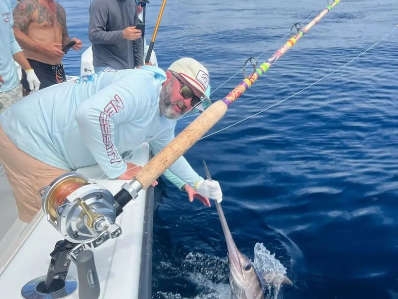 A man fishing with Necessity Deep Sea Fishing Charters