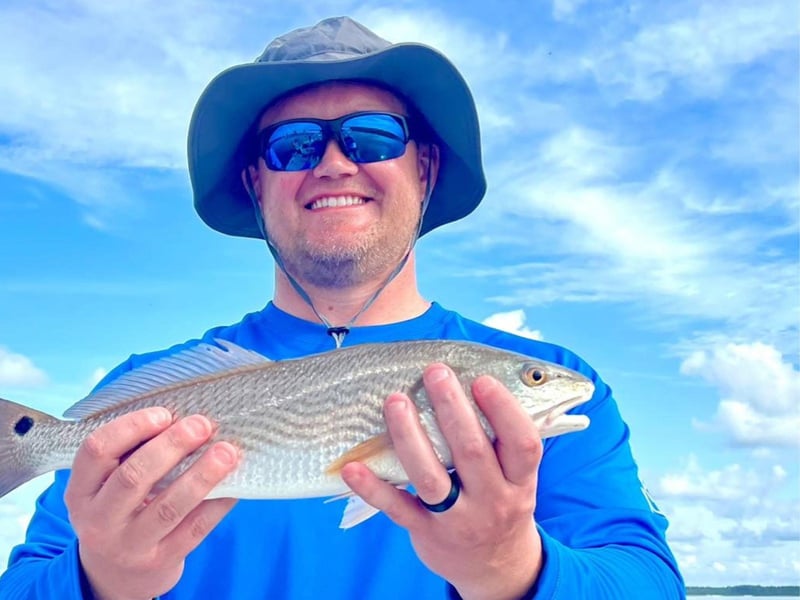 A man showing off his catch from a trip with Book Me a Charter