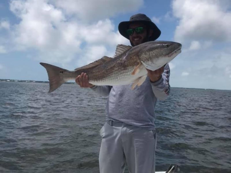 A man showing off his catch in Apalachicola, Florida