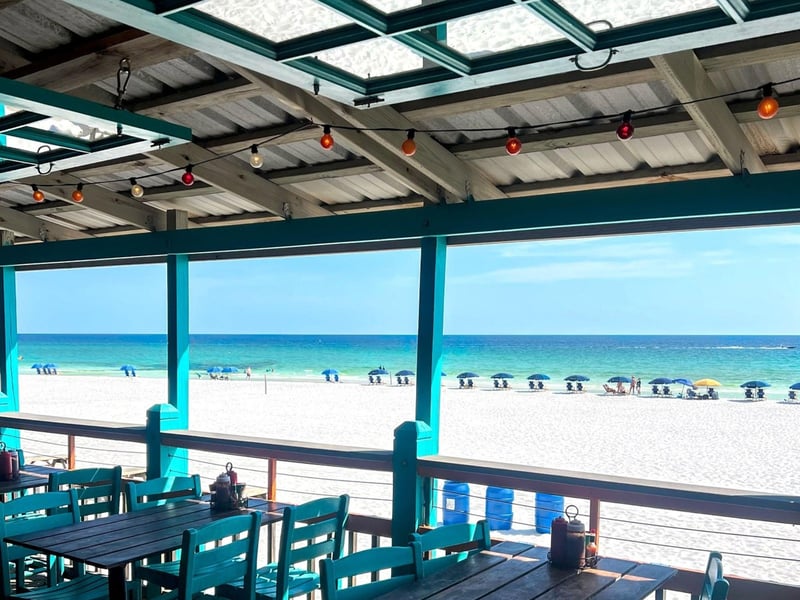 Tables by the beach at The Back Porch in Destin, Florida