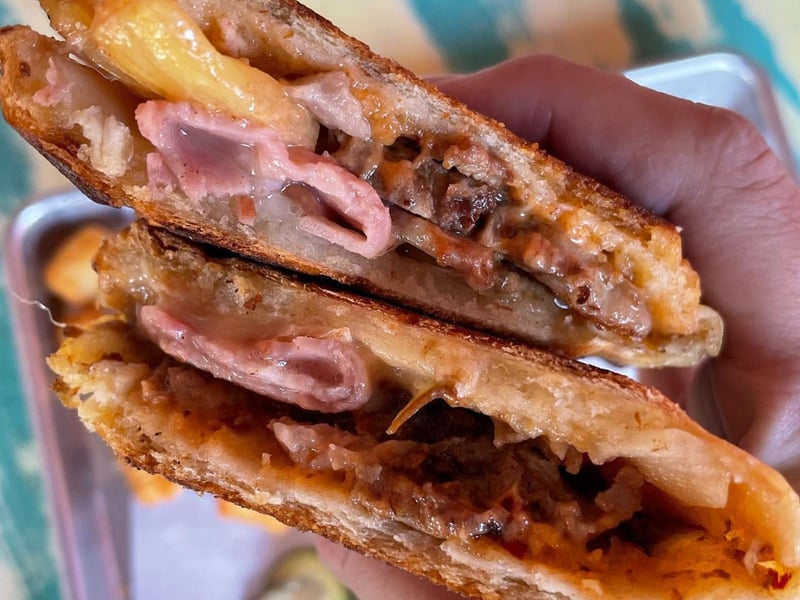 A sandwich al pastor with chipotle aioli