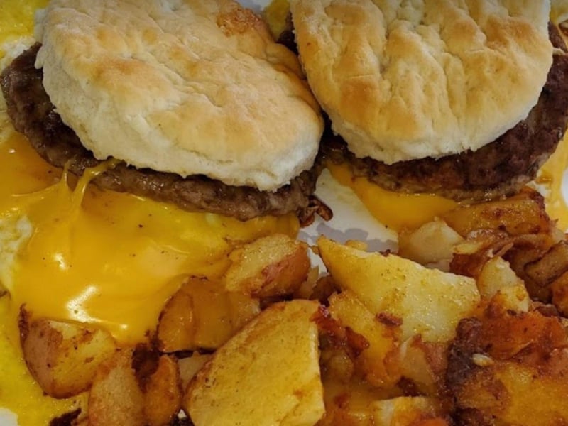 Two biscuit sandwiches with sausage and cheese