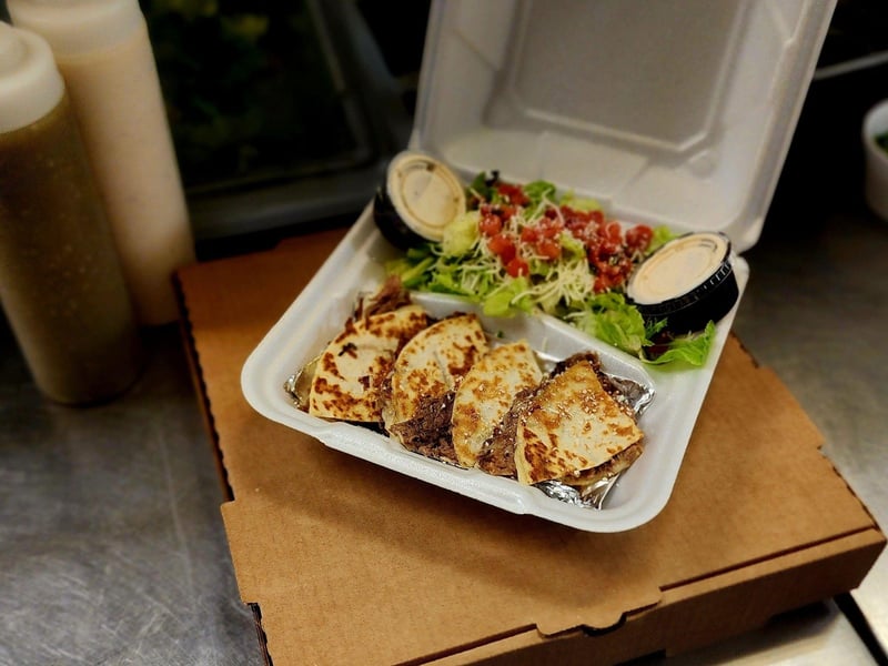 A quesadilla prepared with your choice of meat