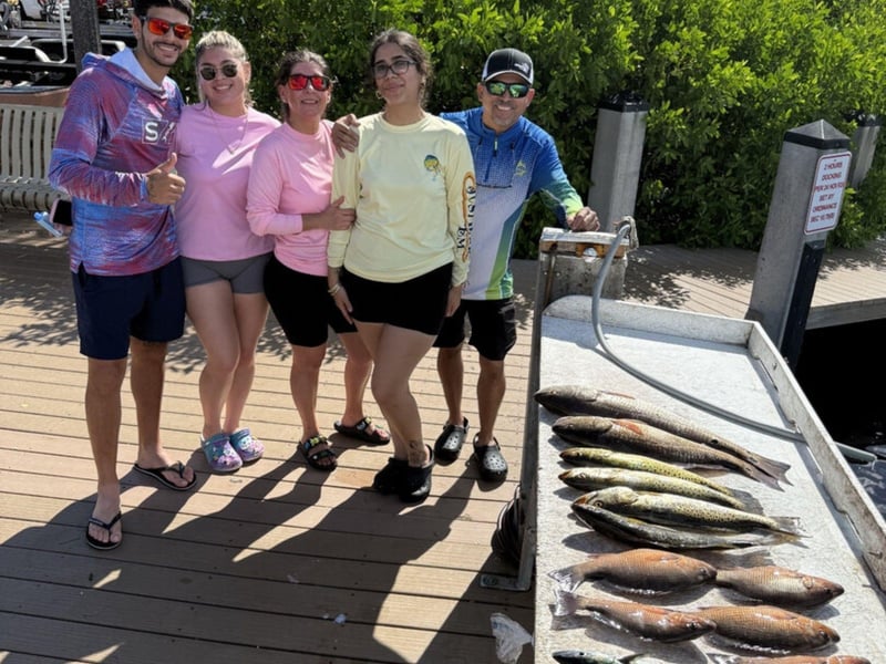 A group with their catches on the dock