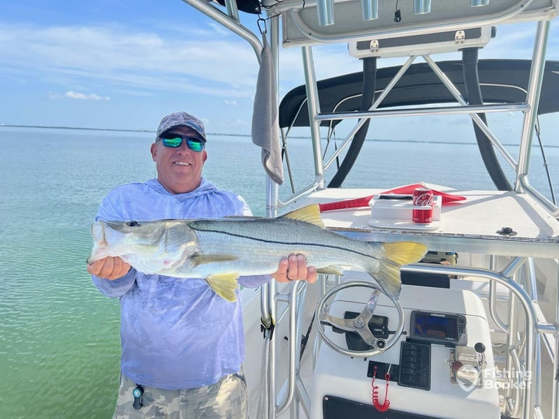 An angler showing off his catch on the boat