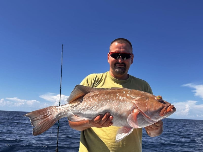 A man showing off his catch with Mother Ocean Charters