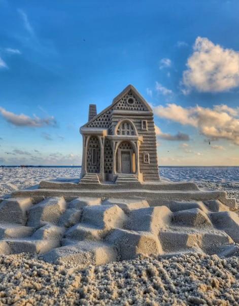 detailed sandcastle house sculpture built on the beach in Gulf Shores, Alabama