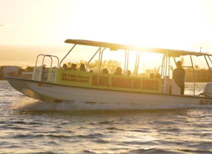 Public sandbar tour boat cruising across calm coastal waters on the way to local sandbars.
