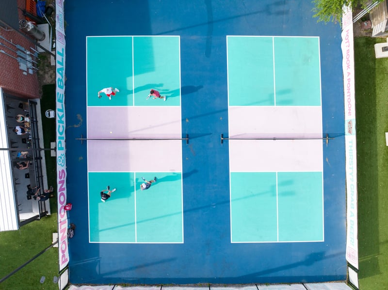 Topdown view of multiple pickleball courts with players at Beach Weekend Fort Walton Beach