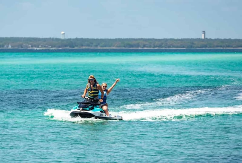Jet ski riders cruising through clear turquoise water near Crab Island in Fort Walton Beach
