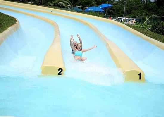 Two riders racing down multilane water slide at Shipwreck Island Waterpark