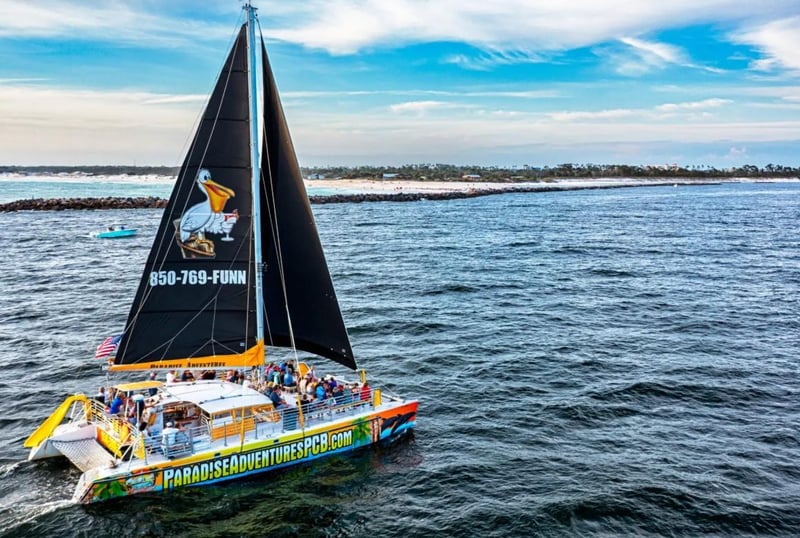 Lazy Daze catamaran sailing through the Gulf with passengers onboard in Panama City Beach